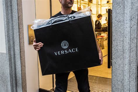 michael kors buys versace for 2 billion|is versace still in business.